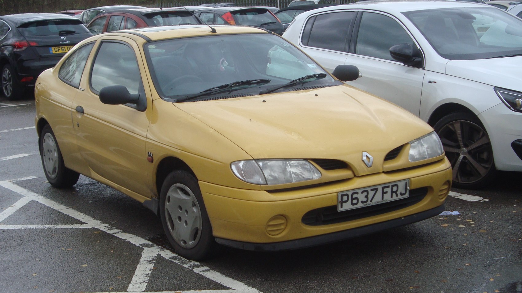 Yellow compact coupe with distinct headlights and front grille