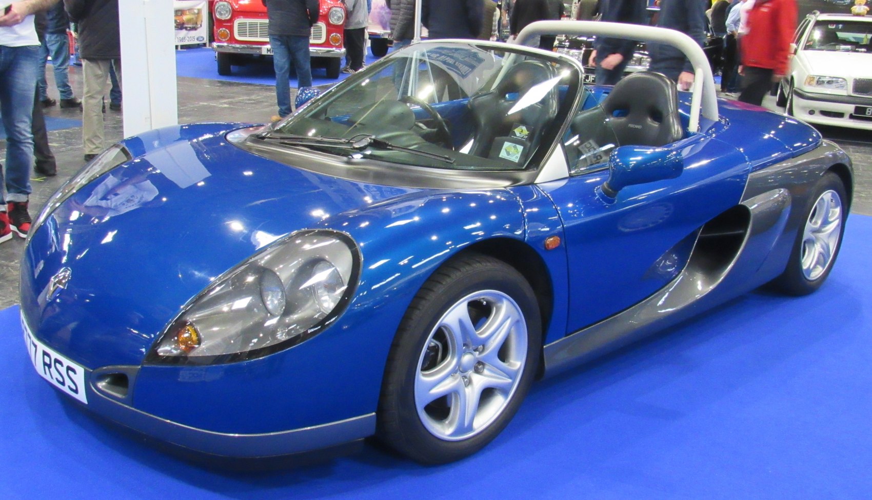 Blue lightweight convertible roadster with roll bar and aerodynamic design