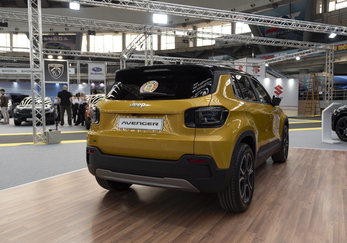 Rear view of a yellow compact SUV with modern taillights and sporty wheels