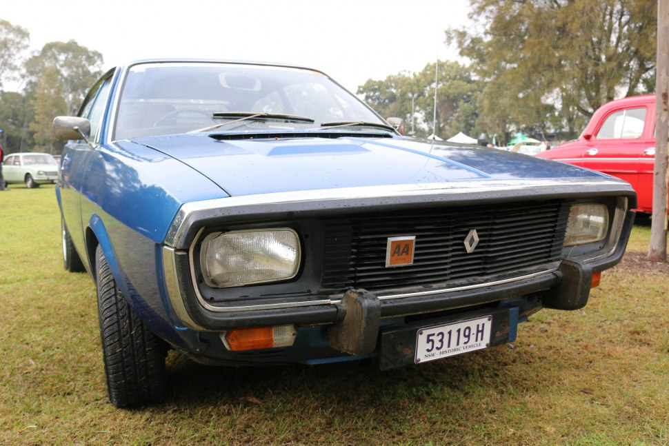 Rectangular headlights and black grille on a vintage car front.
