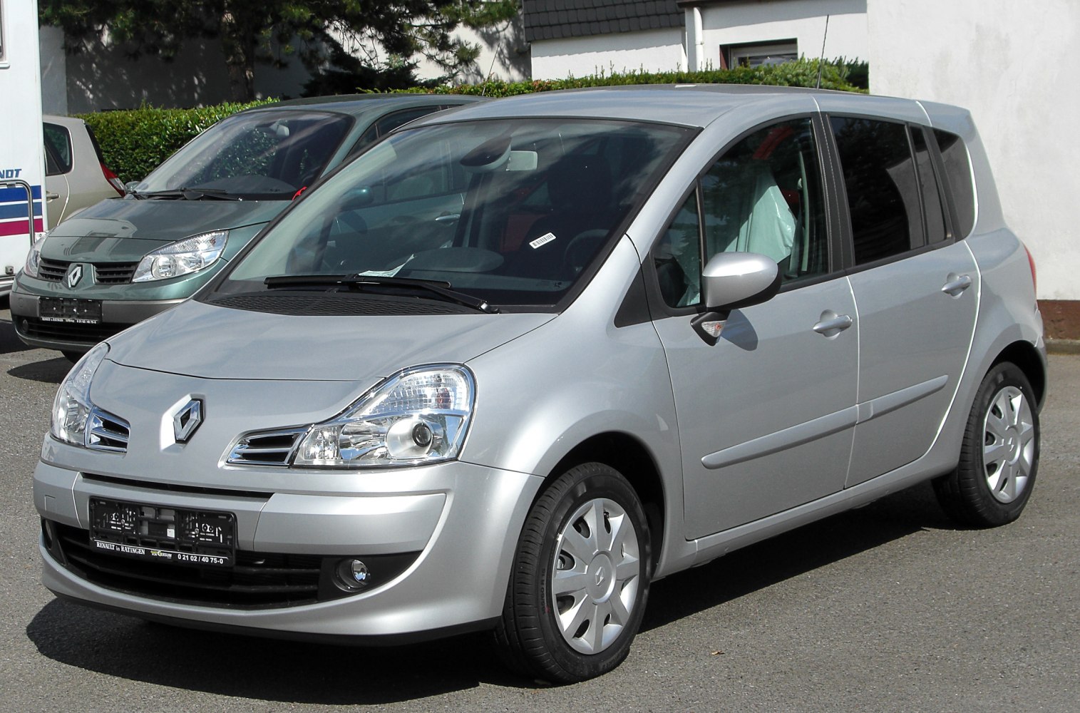 Silver compact MPV with distinctive headlights and smooth body lines