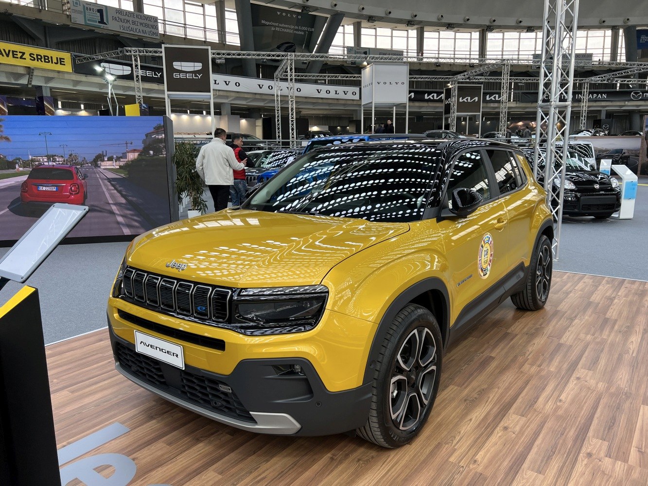 Yellow Jeep SUV with black roof, modern grille, and sleek headlights