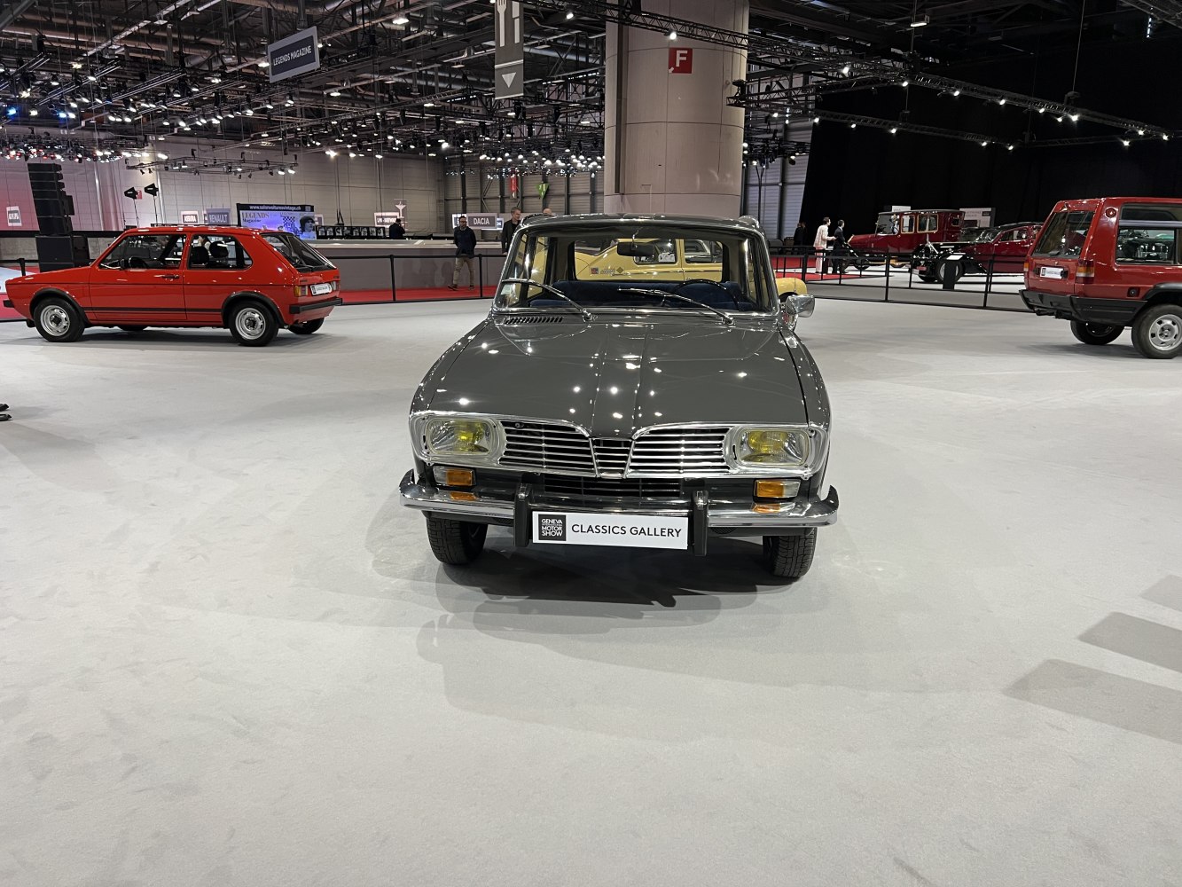 Front view of vintage vehicle with dual headlights and chrome bumper