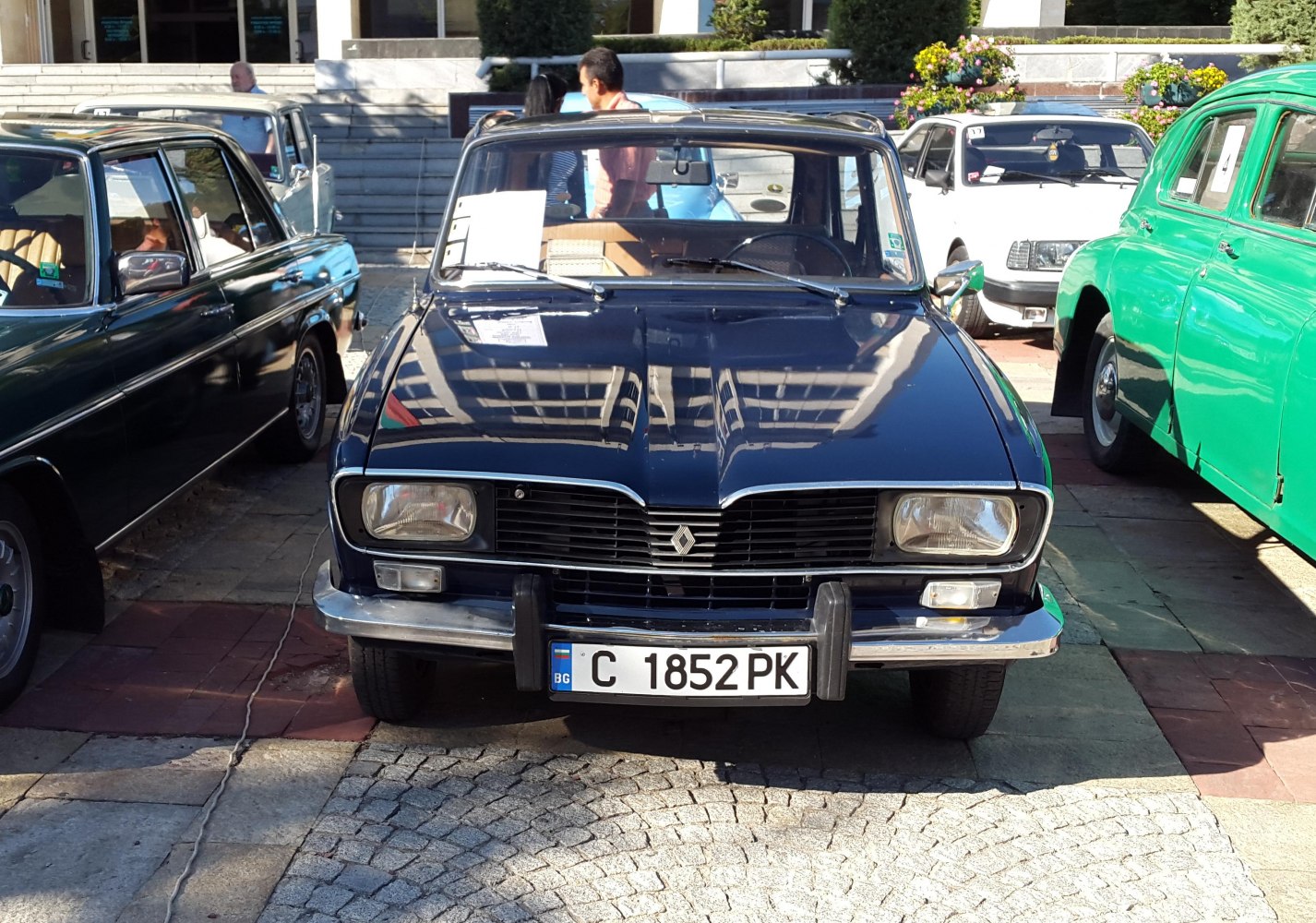 Vintage sedan front view with rectangular headlights and chrome bumper