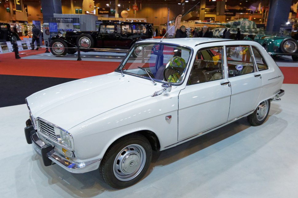 Five-door white hatchback with steel wheels and vintage design.