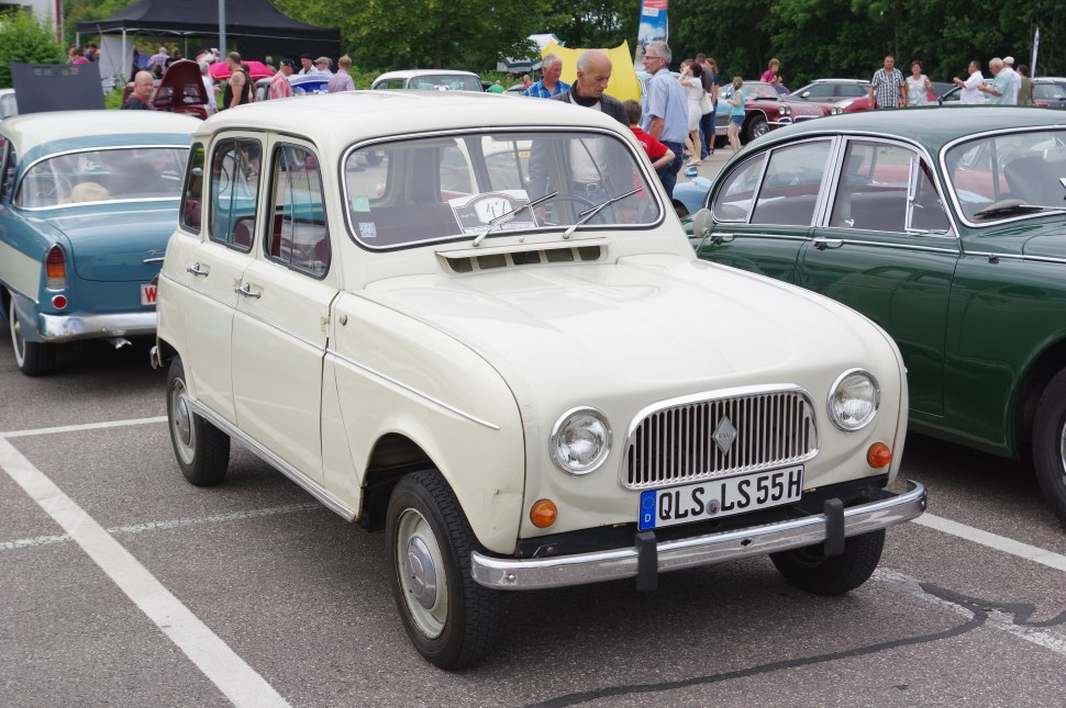 Classic front grille and round headlights on compact four-door vintage car