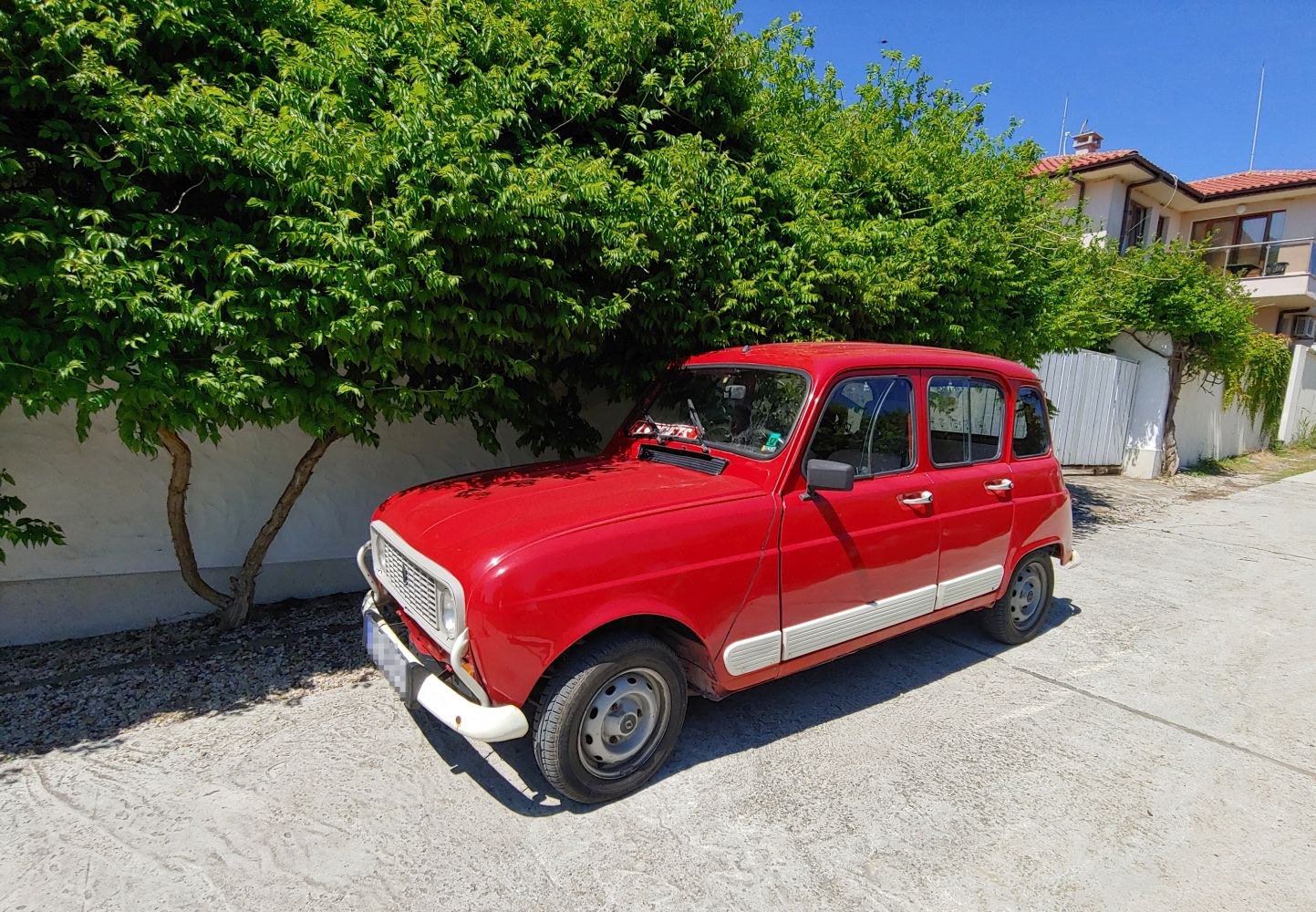 Vintage compact car with distinct front grille and simple wheel covers