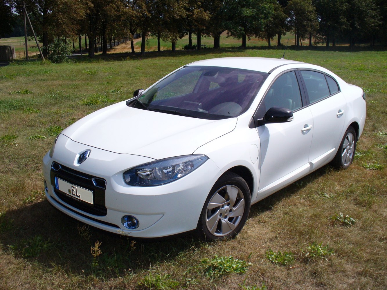 Electric sedan front-side view with compact design and clear headlight details.
