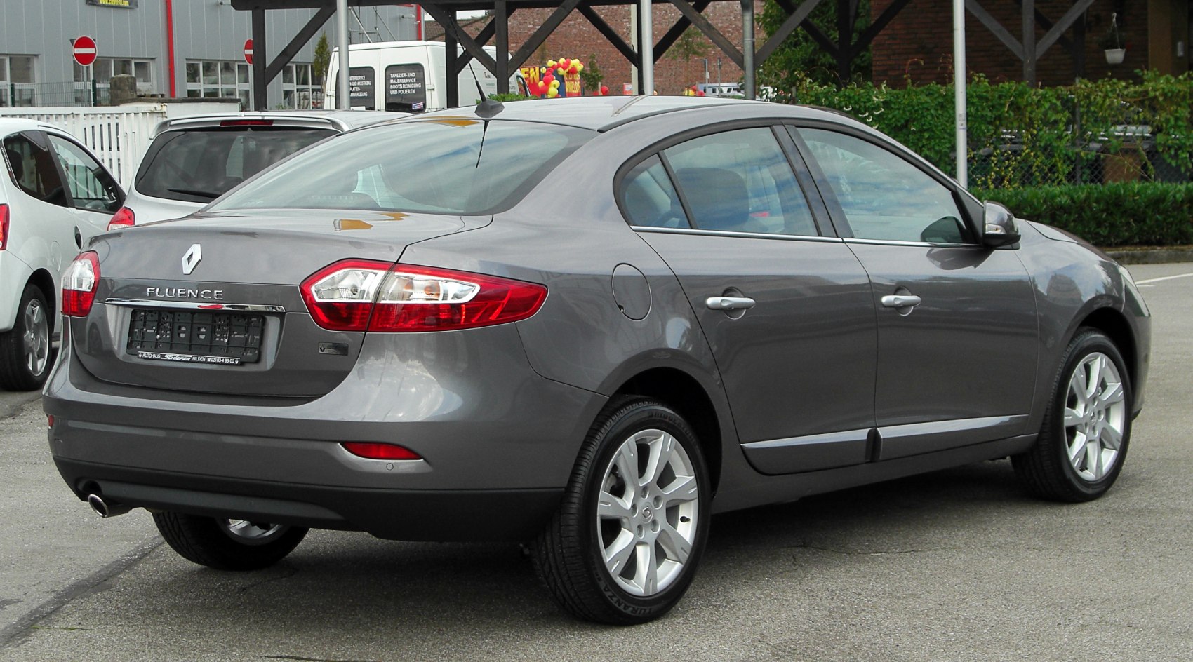 Sedan rear view with distinctive tail lights and alloy wheel rims