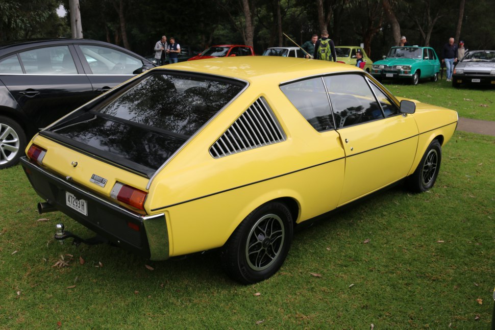 Yellow vintage hatchback with rear window louvers and black alloy wheels