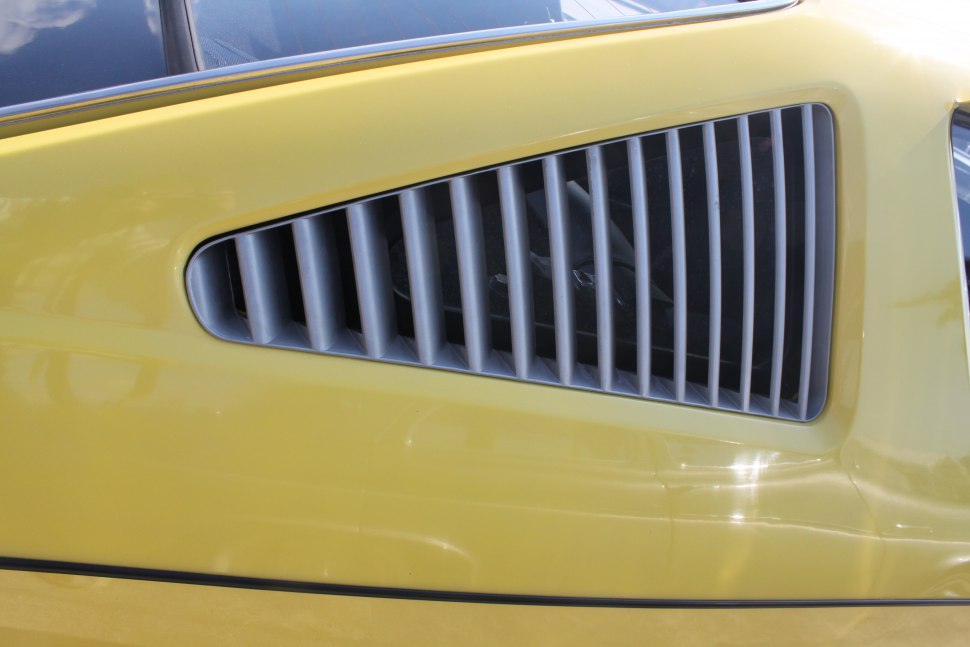 Close-up of classic car side vent with vertical slats