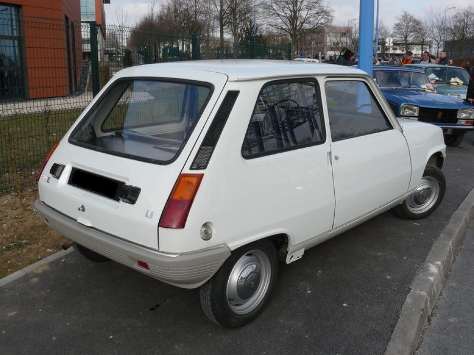 Rear view of a classic 1970s hatchback with vertical tail lights and large rear window.