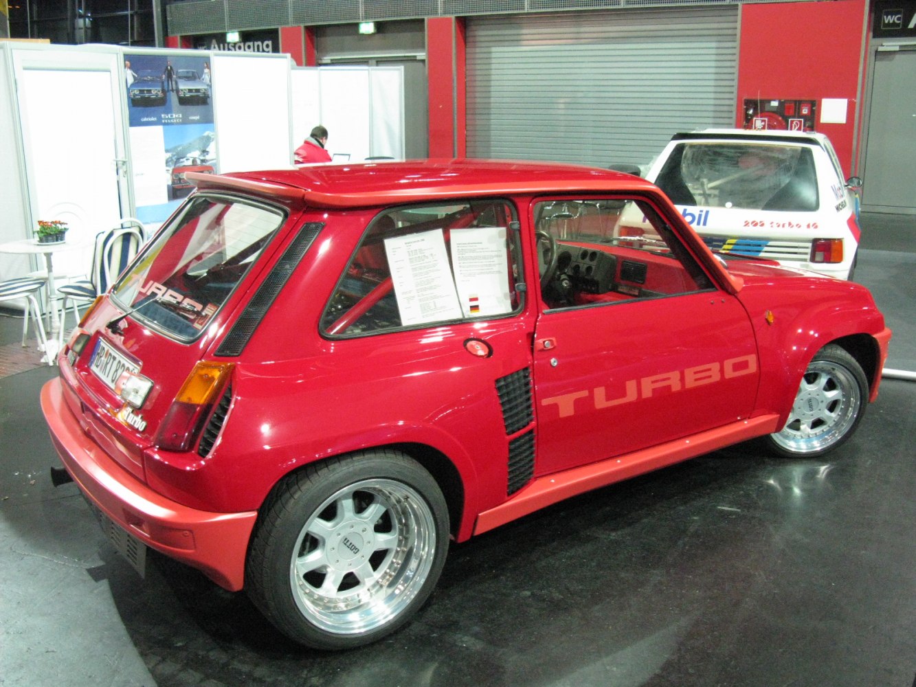 Red hatchback with turbo side vents and wide alloy wheels
