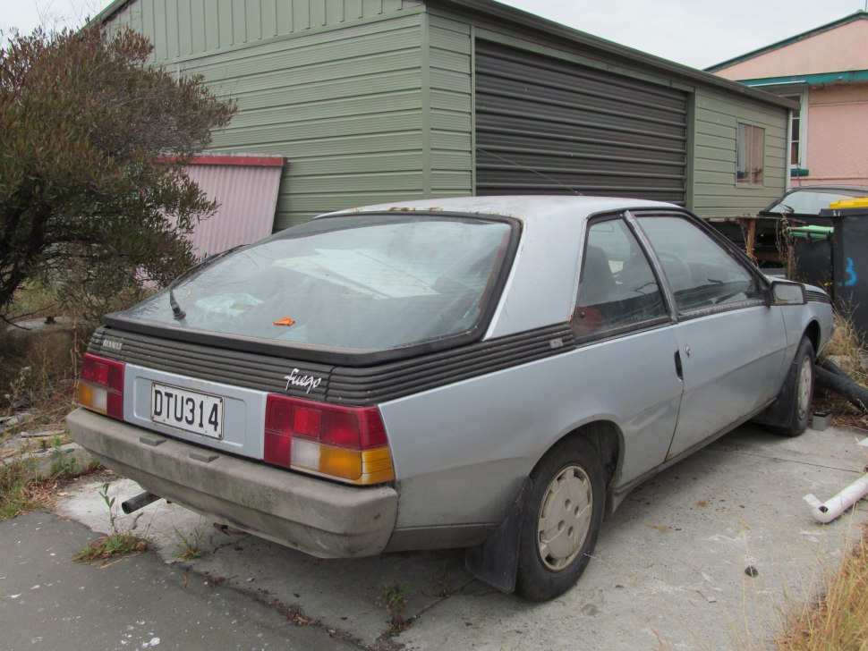 Rear side of hatchback with textured panel and older taillights