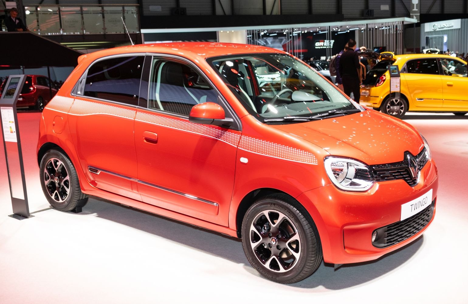 Red compact hatchback with distinctive side stripe and stylish alloy wheels
