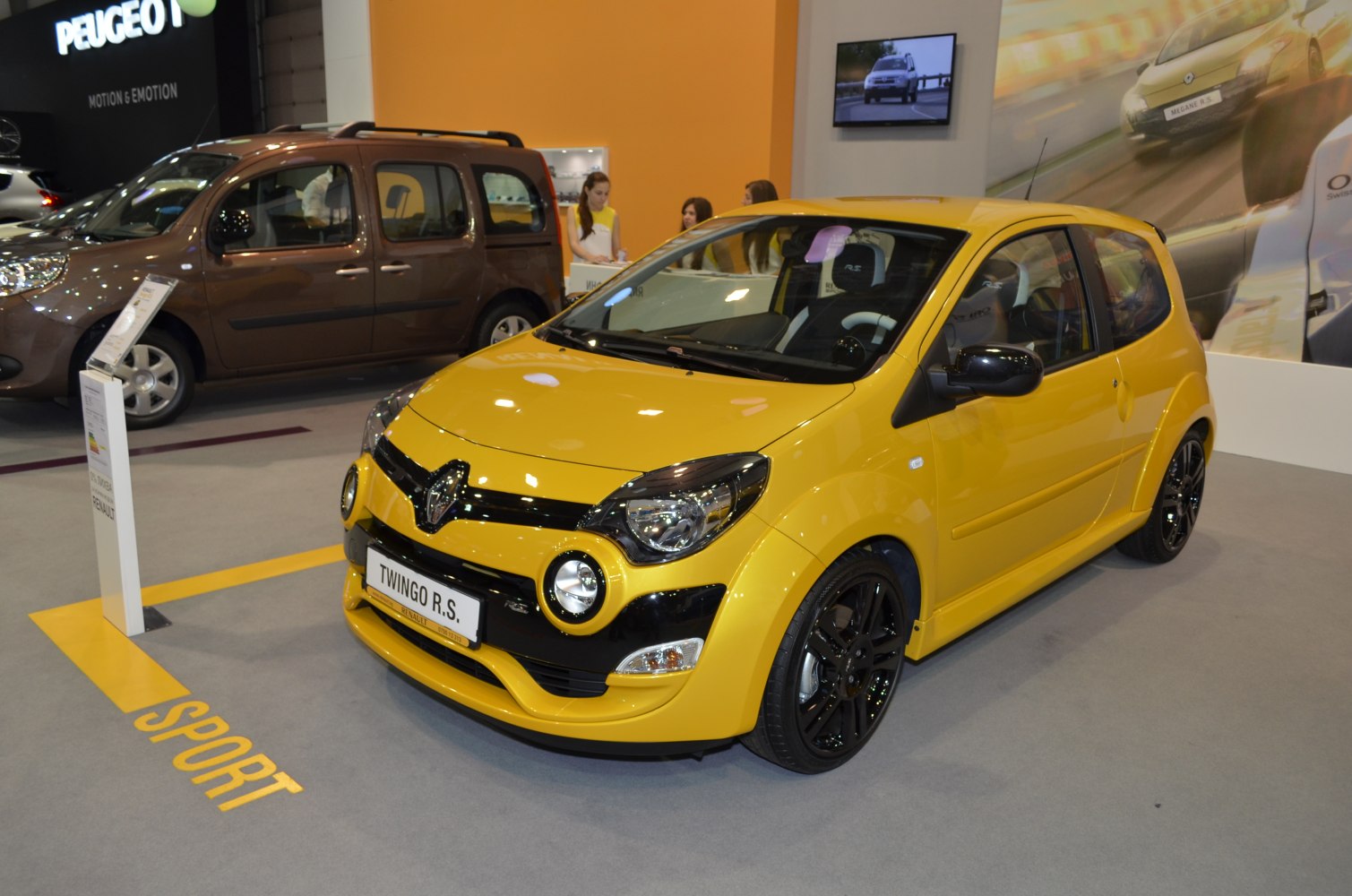 Yellow sporty hatchback front view with black rims and accents