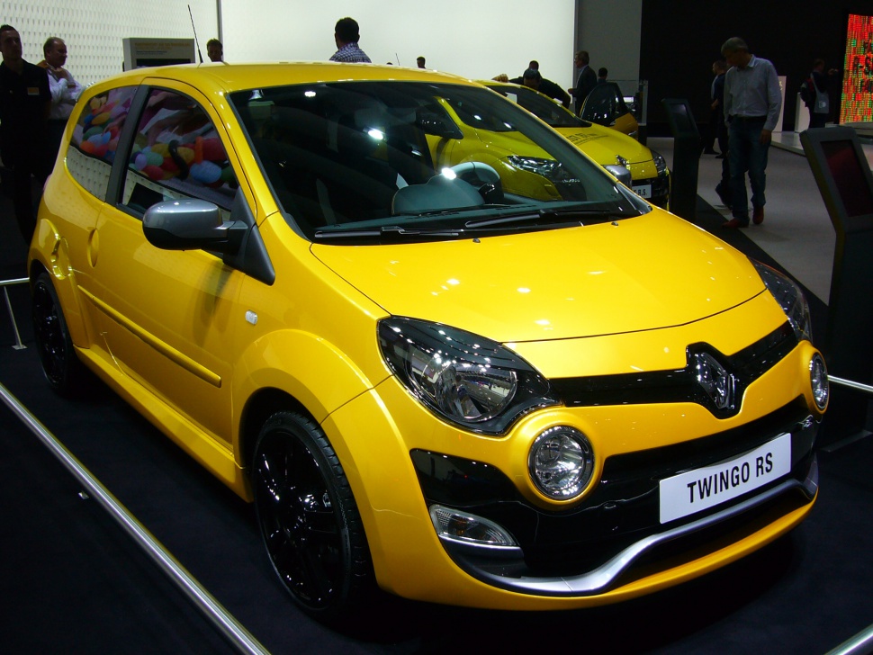 Yellow compact hatchback with unique circular fog lights and black wheels
