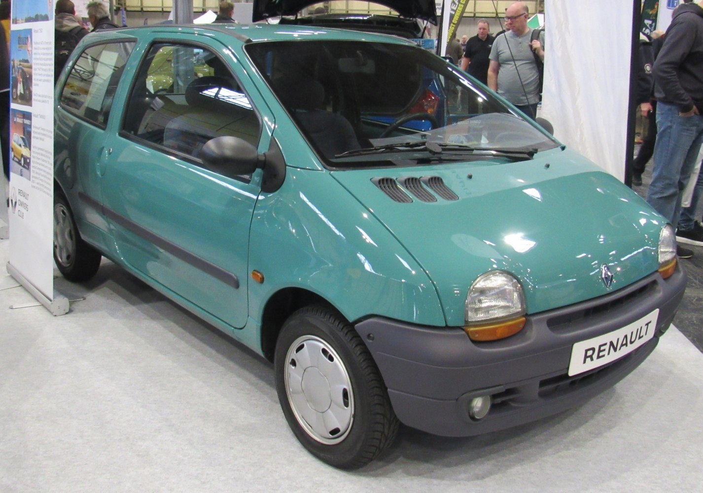 Compact hatchback with rounded headlights and front hood vents