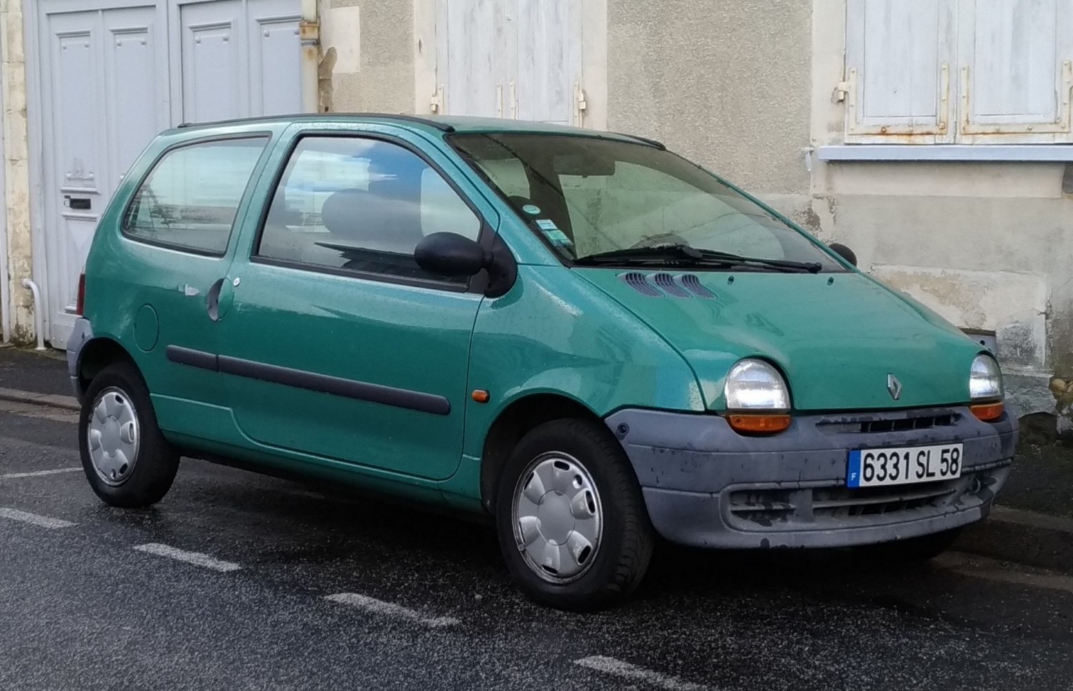 Compact hatchback with rounded headlights and prominent black plastic bumper
