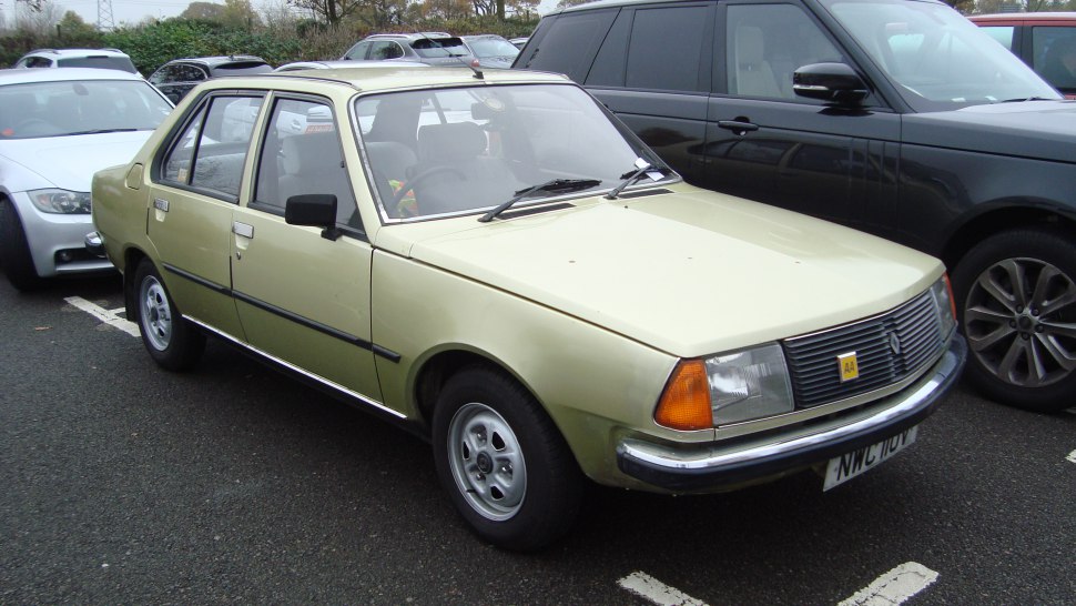 Front side view of a classic 1970s sedan with rectangular headlights and simple grille