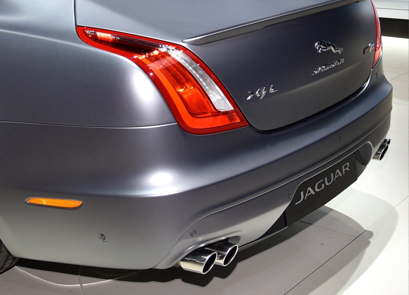 Rear end with tail light, Jaguar XJ Long emblem, and dual exhaust pipes.