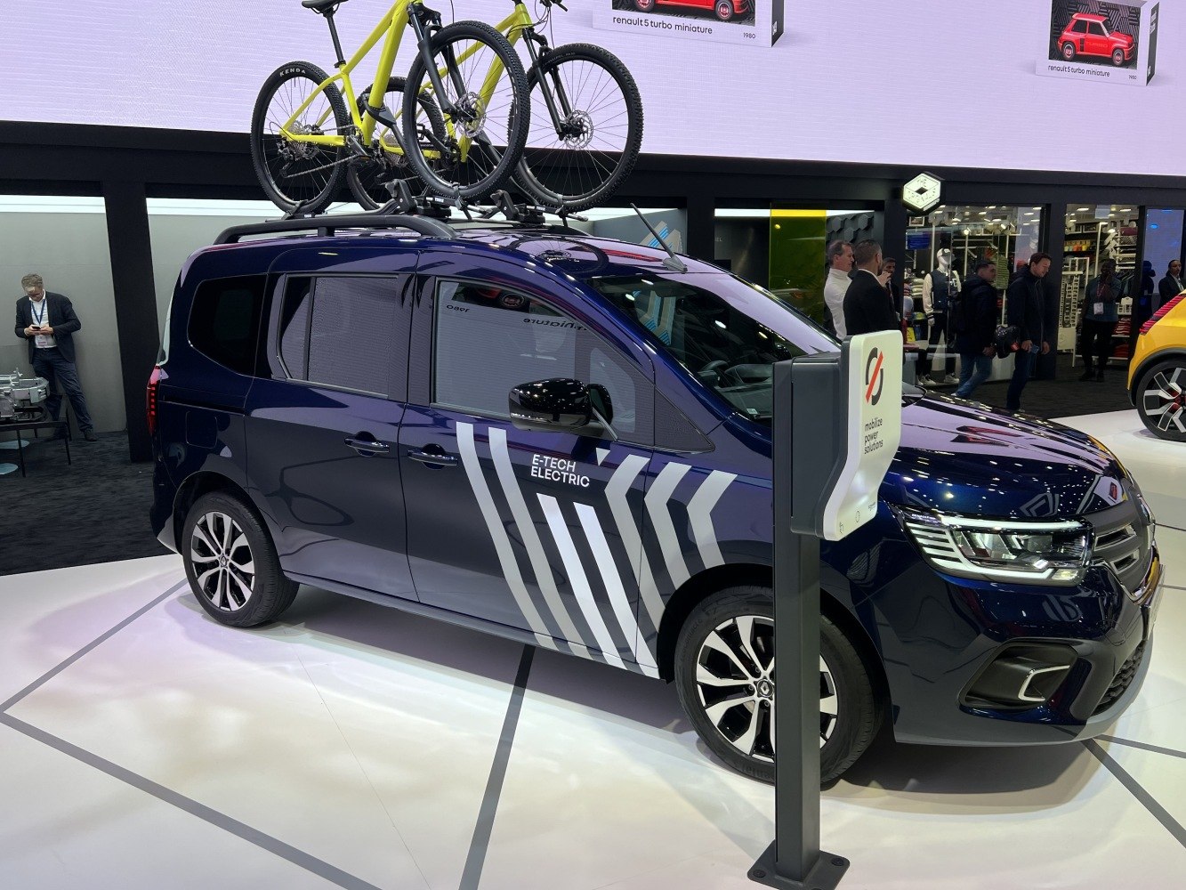 Electric van with roof-mounted bicycles and charging station