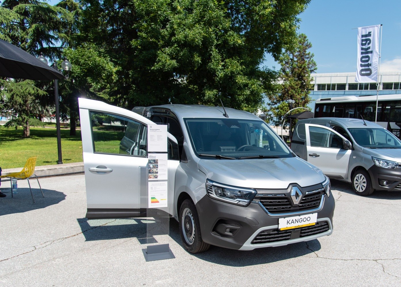Front view of a grey light commercial vehicle with open driver door