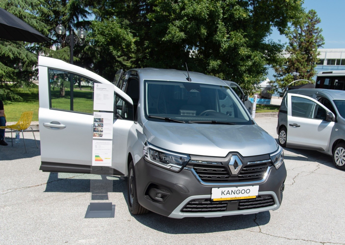 Front and side view of van with open driver door