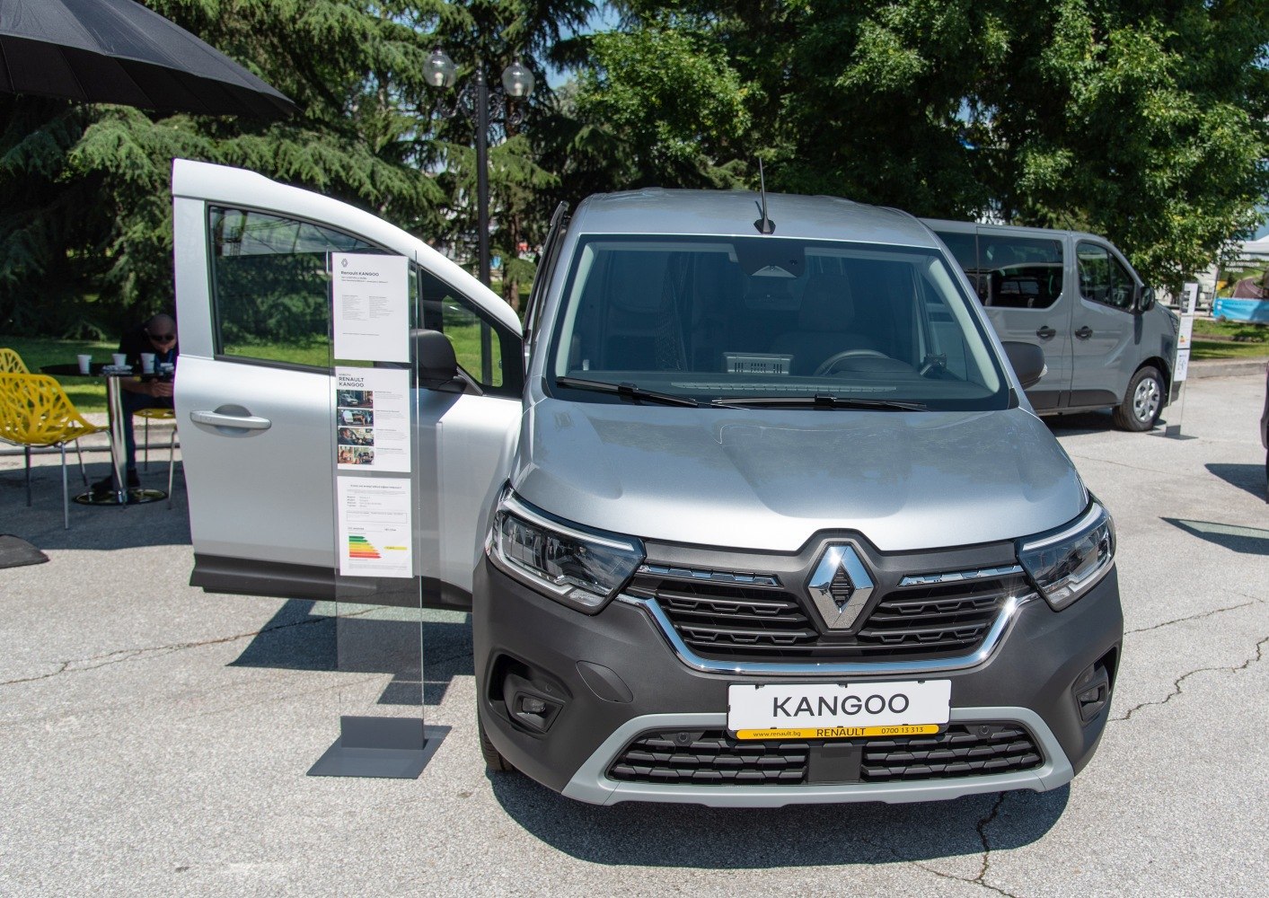 Silver utility van front view with open driver door