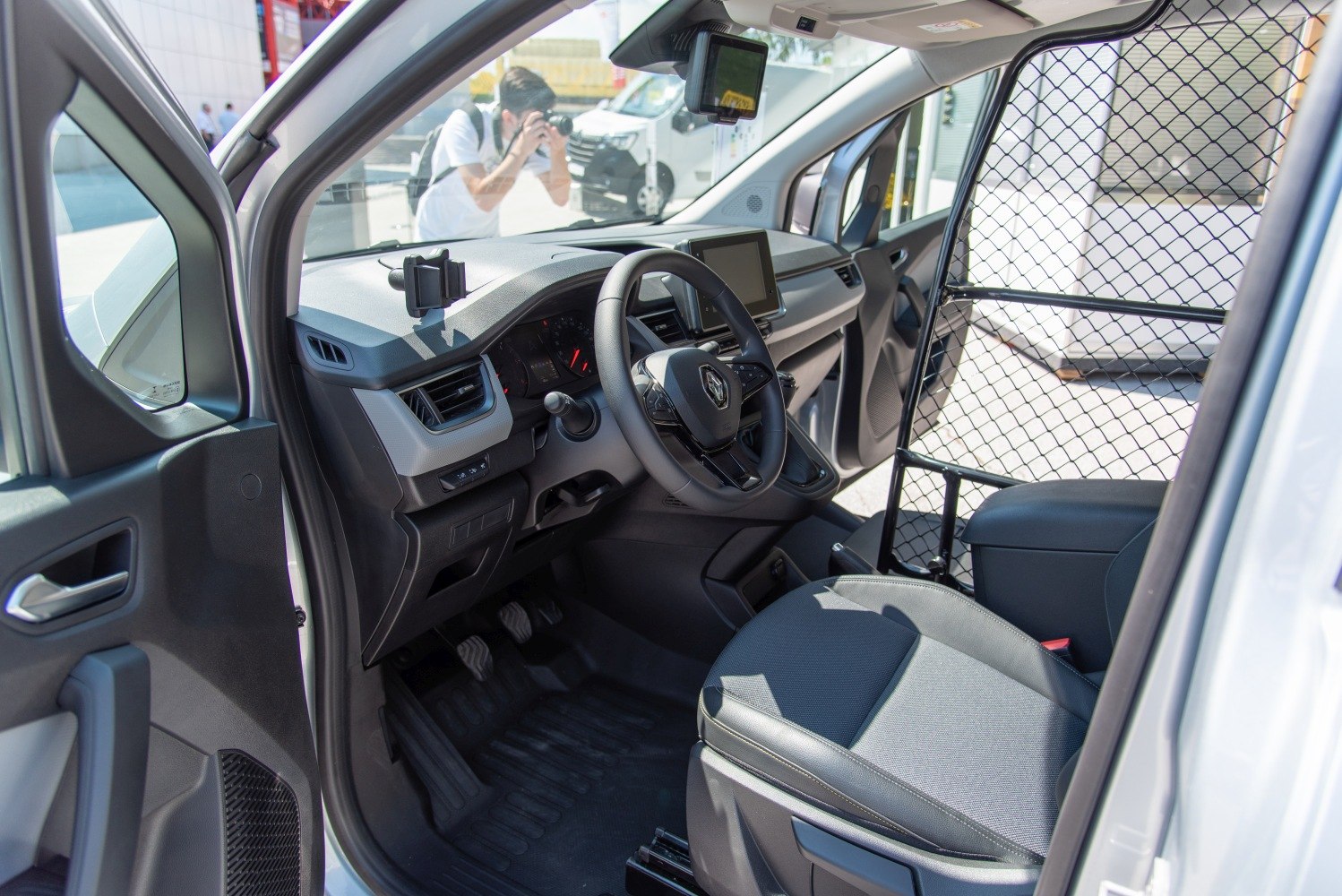 Driver's cabin with steering wheel, dashboard, and partition cage