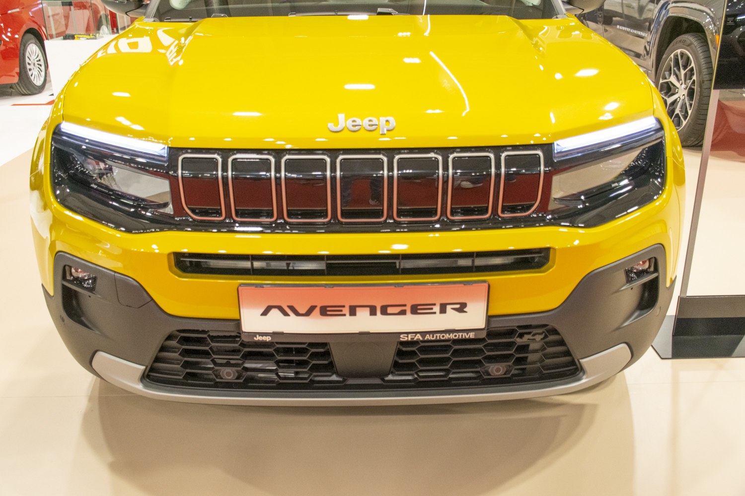 Front grille and LED headlights of a yellow SUV