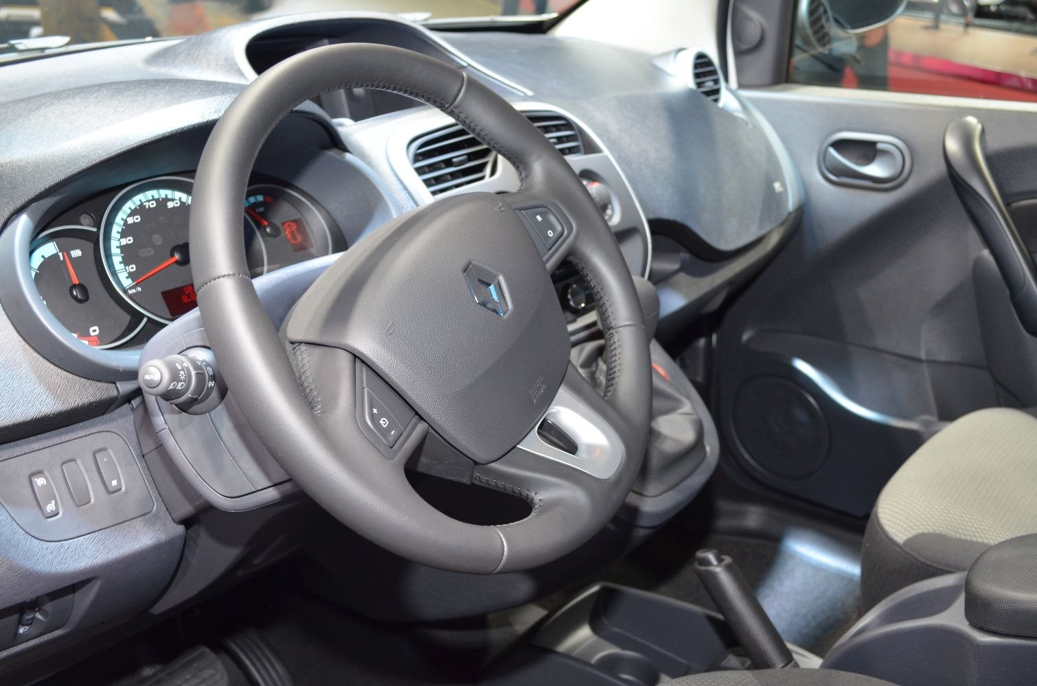 Close-up of steering wheel and dashboard with instrument cluster