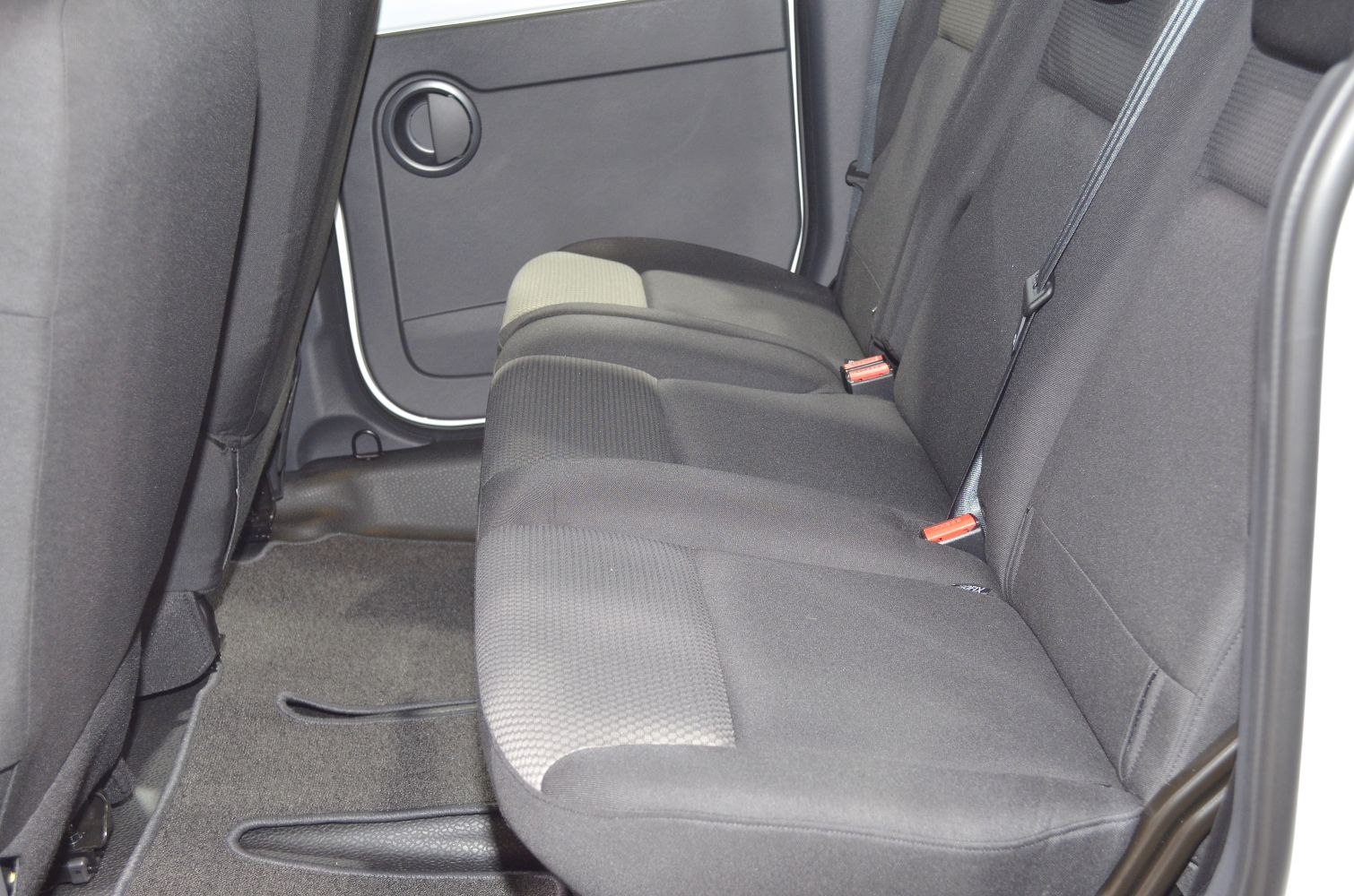 Rear passenger fabric seats with seat belts and door panel.
