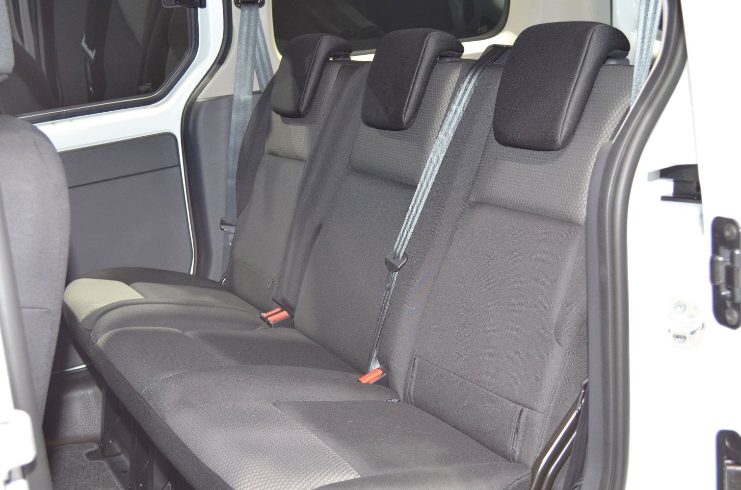Spacious rear seats with headrests and seat belts in a vehicle interior