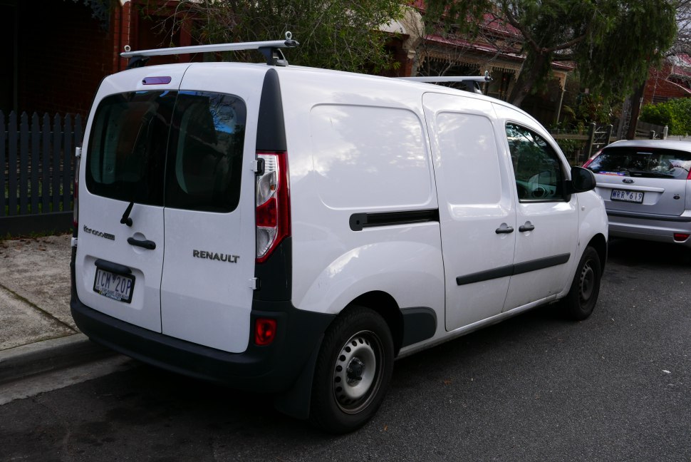 Rear and side view of white panel van with roof rack