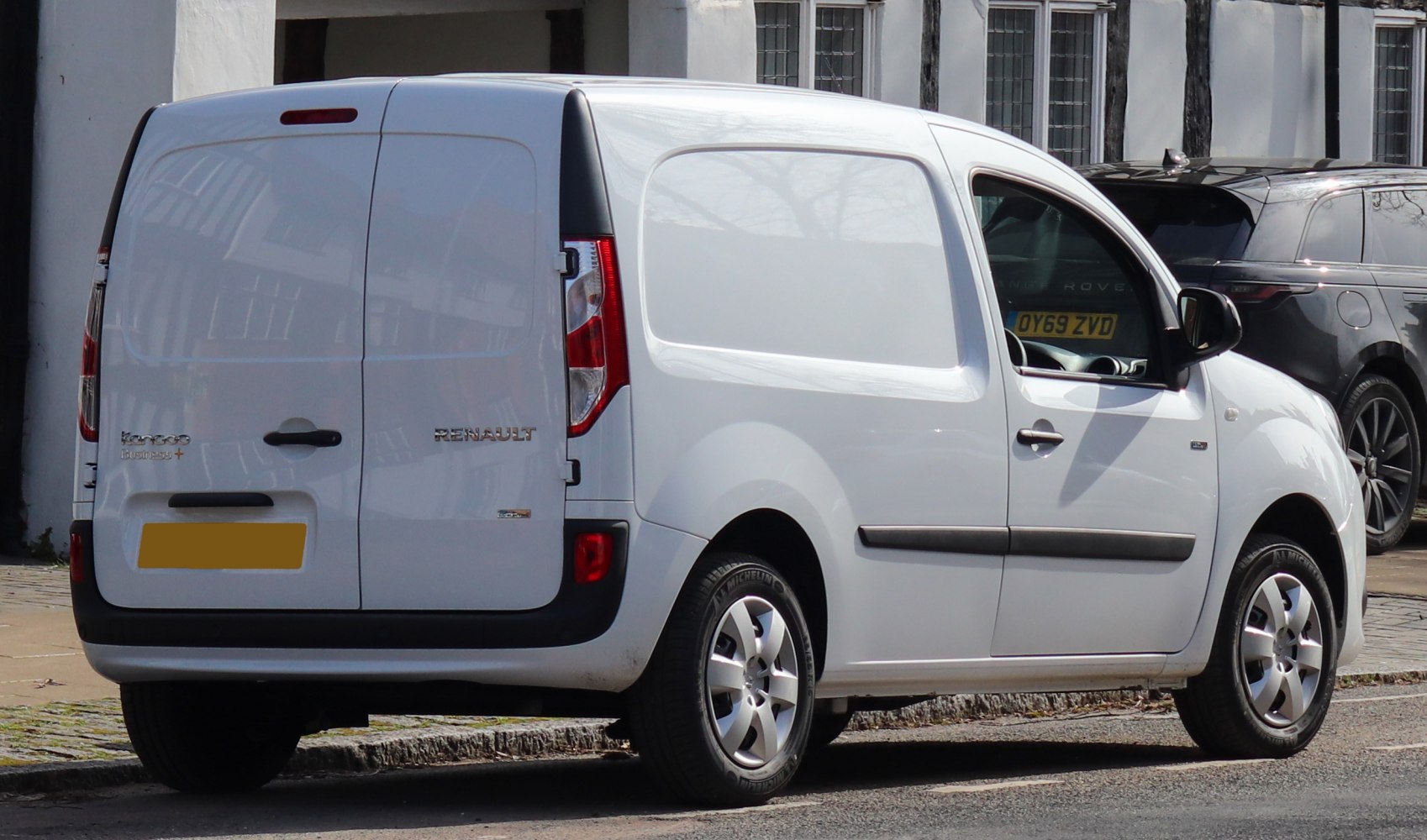 White cargo van with rear double doors and solid side panel