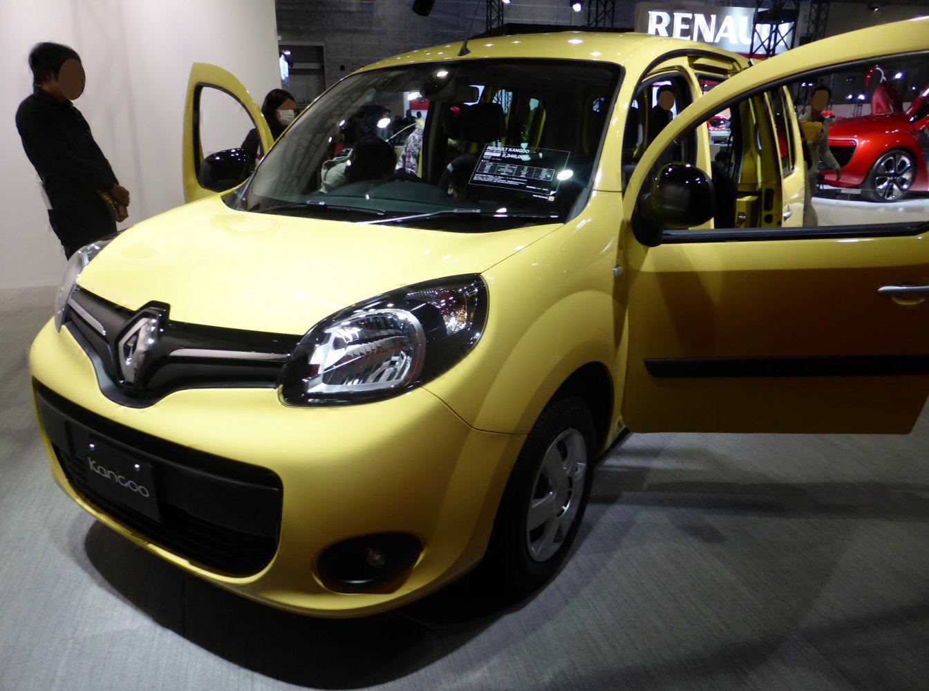 Yellow compact MPV with front and rear doors open