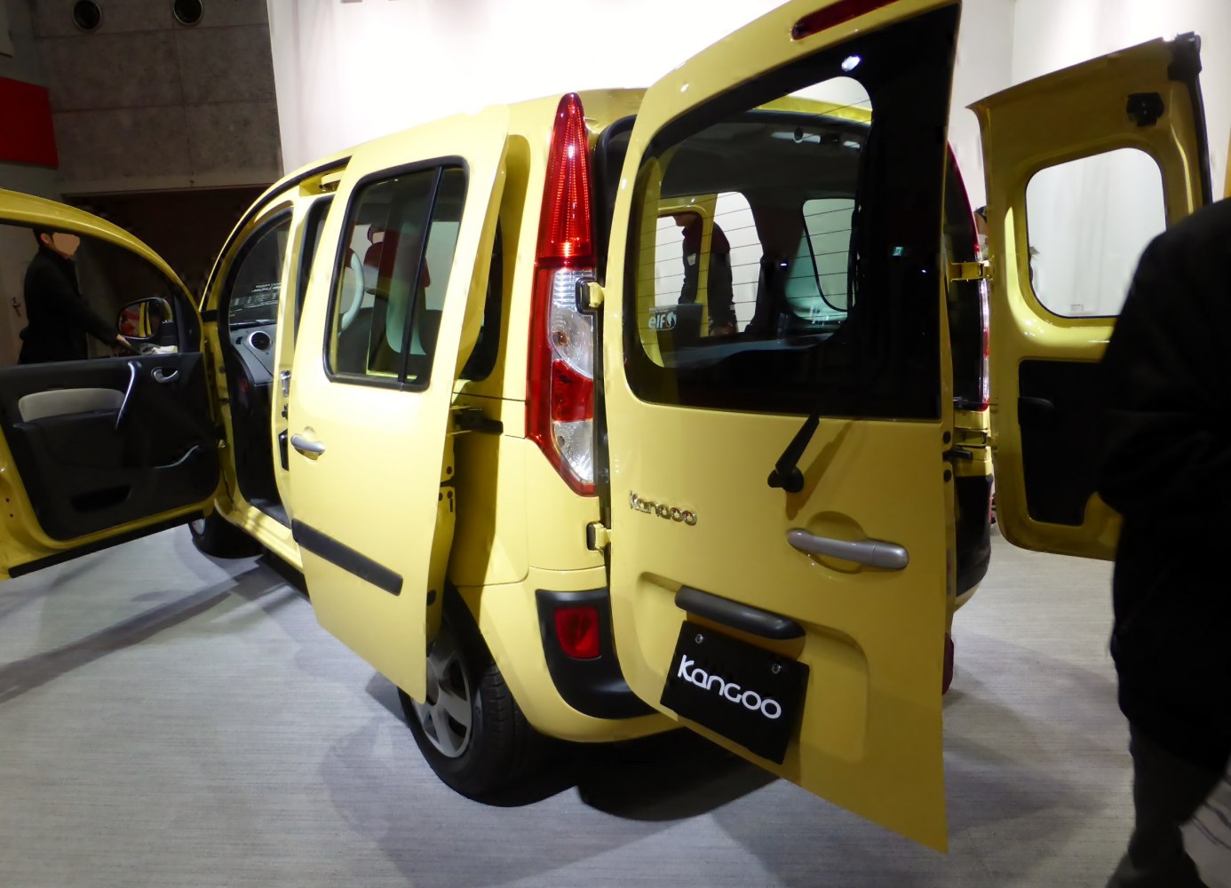 Yellow MPV with open rear and side doors