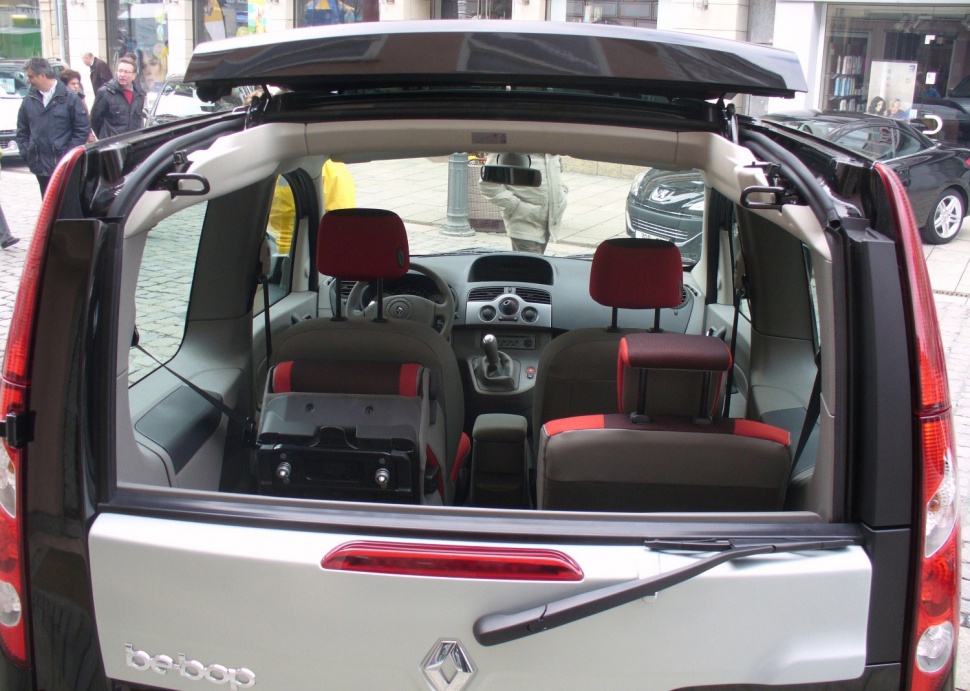Open rear hatch showing dashboard and rear seats with red headrests