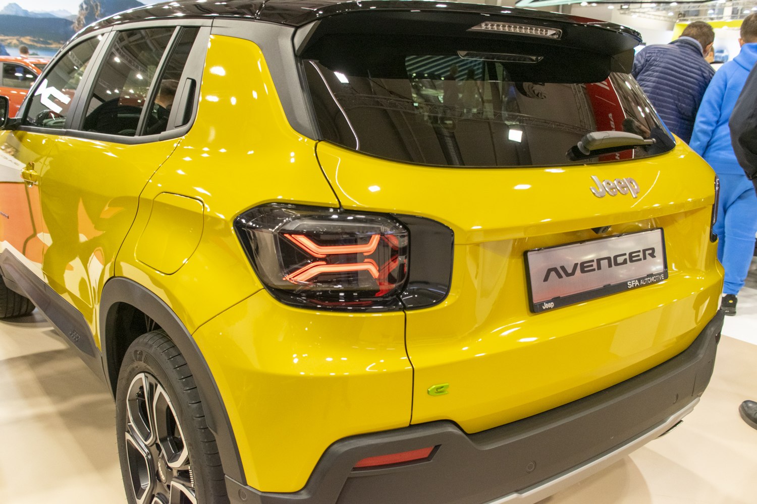 Rear view with distinctive taillights and bright yellow paint