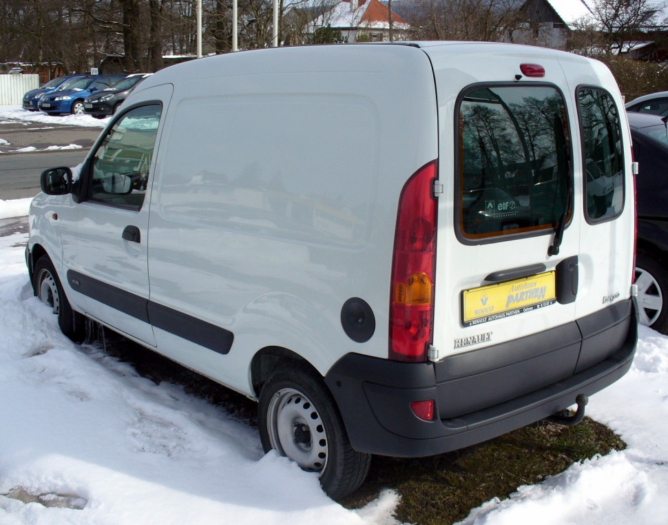 Compact white panel van with dual rear windows and black bumper in snowy setting