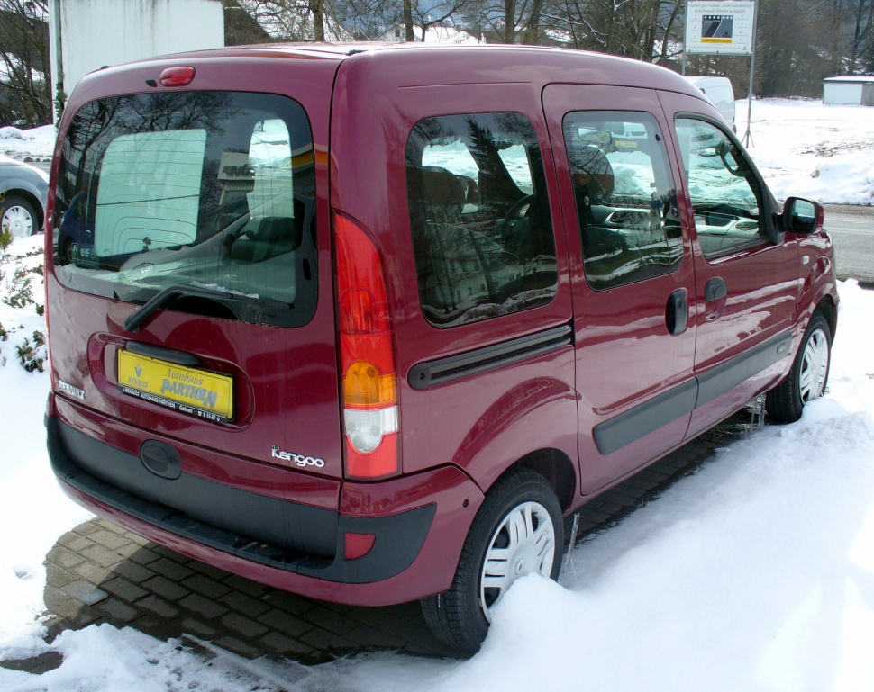 Rear side view of a compact multi-purpose van with sliding door and vertical taillights in snowy setting
