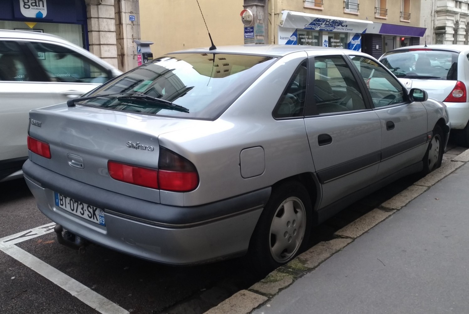 Rear view of sedan with facelifted taillights and hatchback styling.
