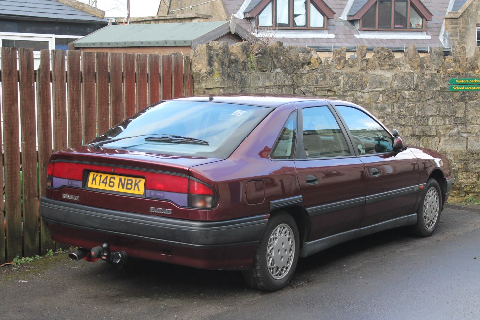 Rear view of a 1990s classic sedan with distinctive taillights and smooth body lines