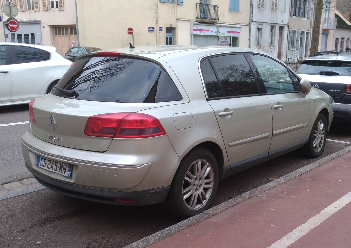 Rear-side view of a hatchback with tinted windows and distinctive taillights.