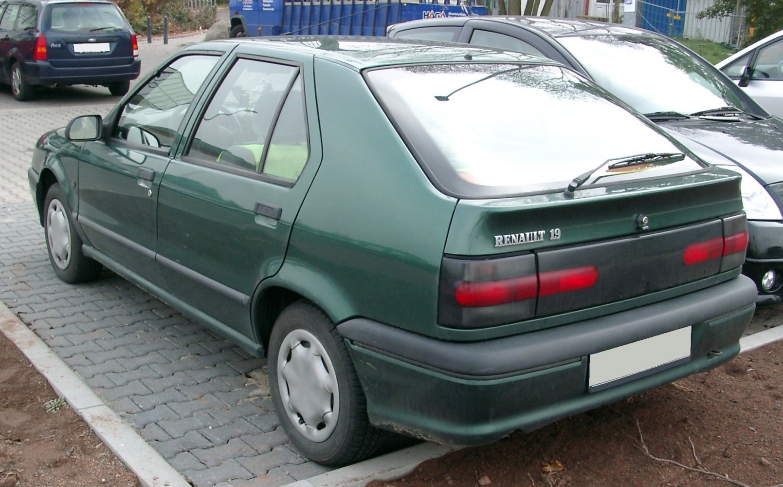 Rear side view of a classic 1992 facelift hatchback with distinctive taillights and rear wiper