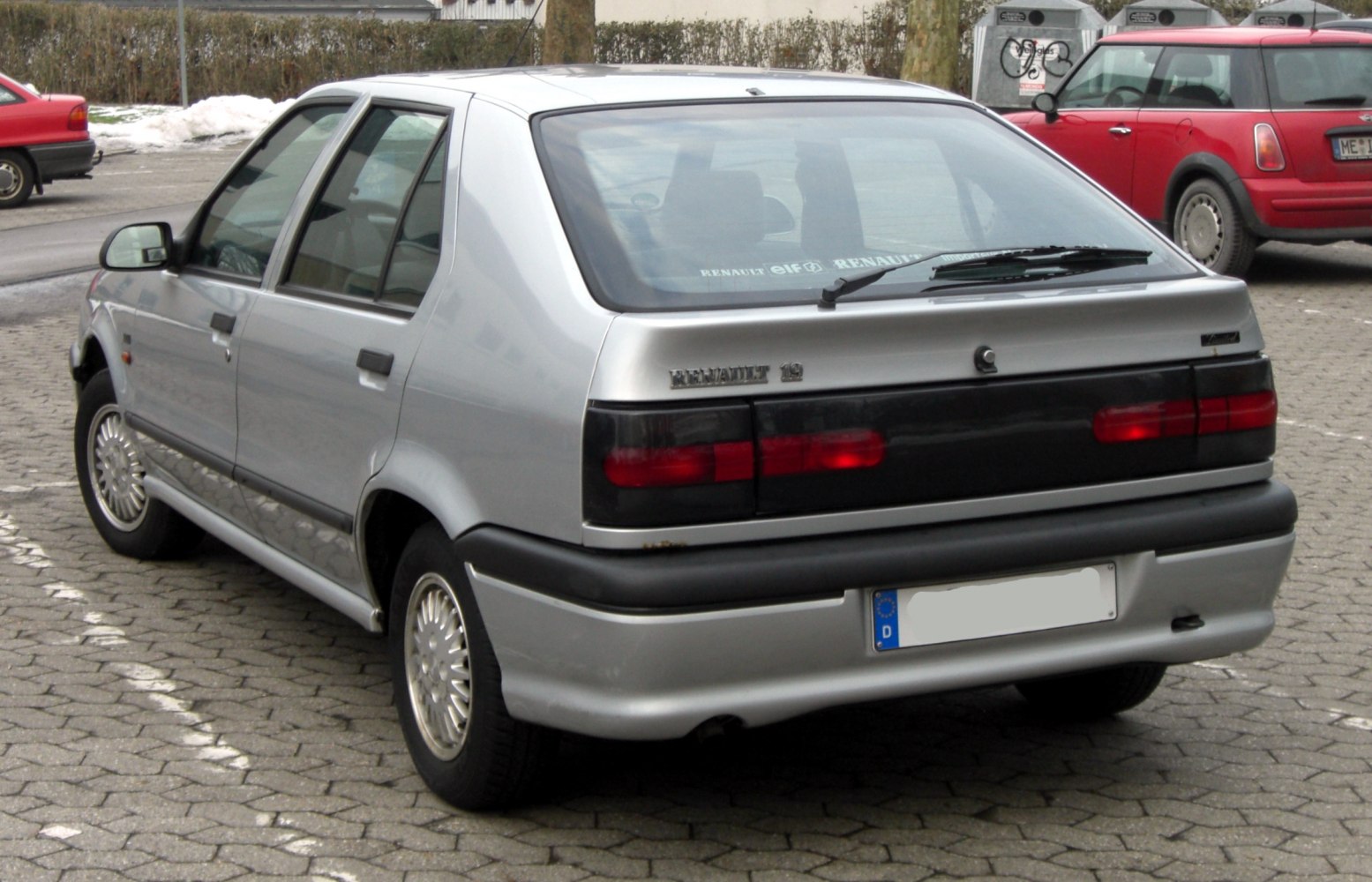 Rear view of a silver classic hatchback with distinct tail light design
