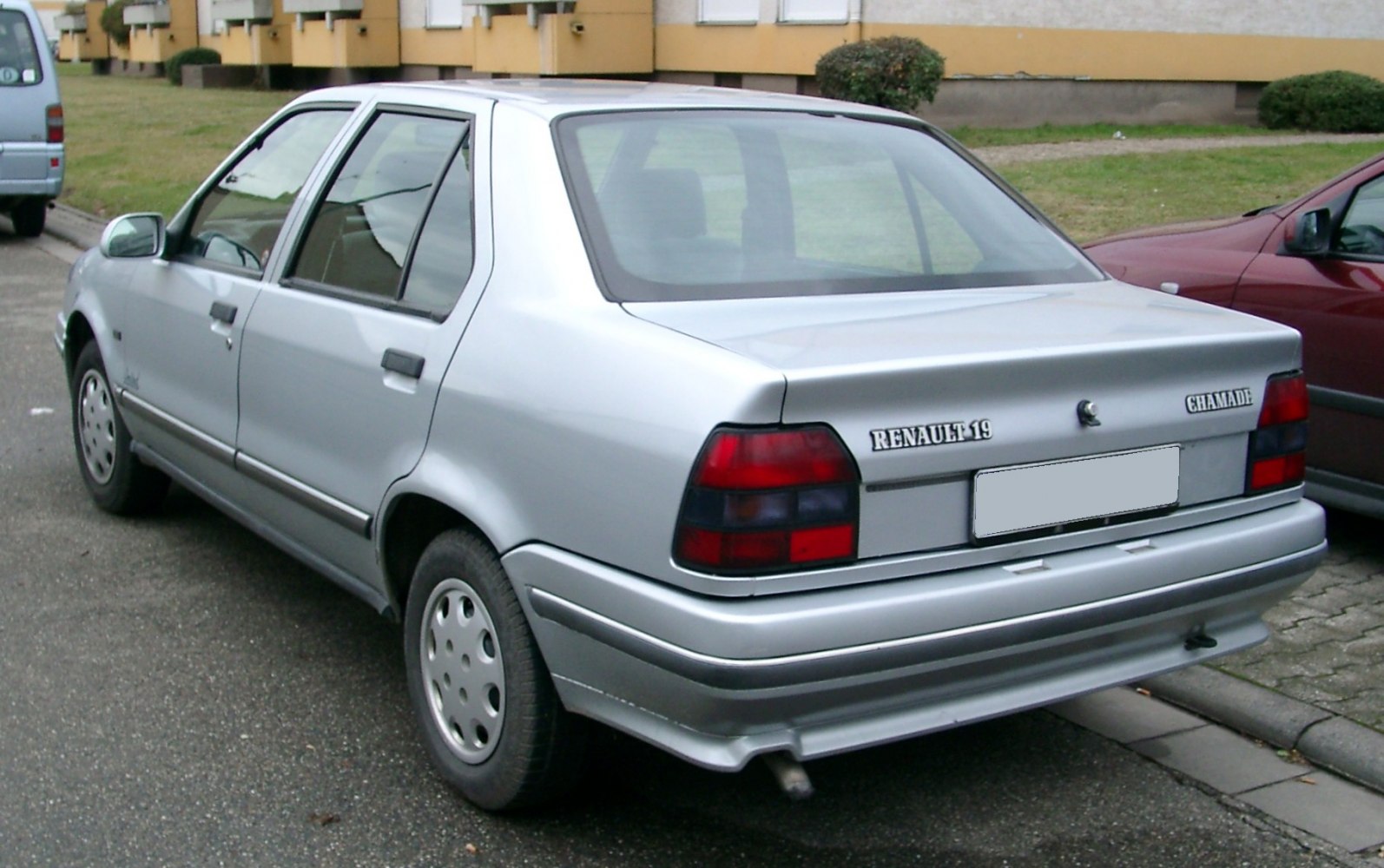 Silver sedan rear view with classic taillights and exhaust pipe
