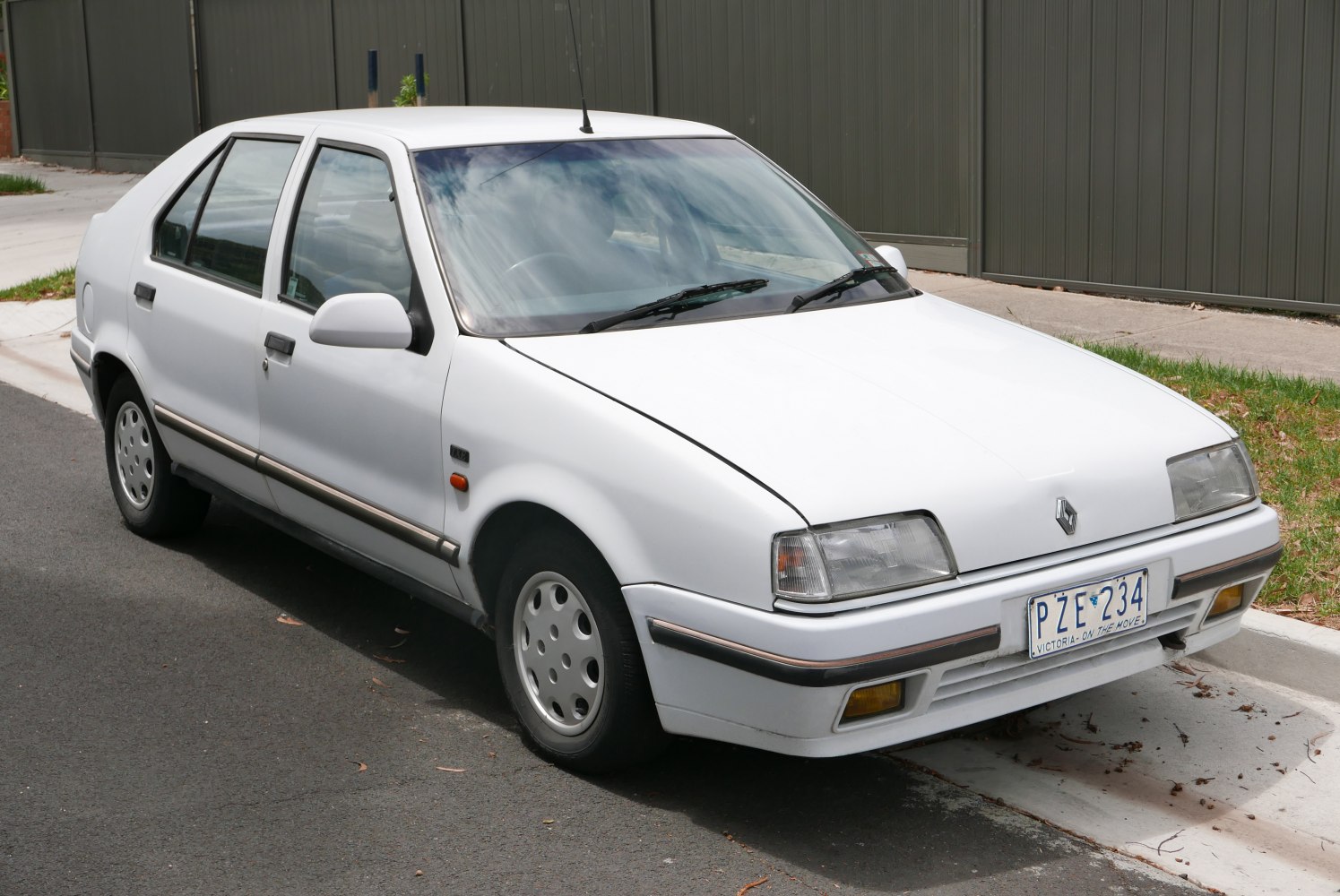 Classic white sedan with rectangular headlights and alloy wheels