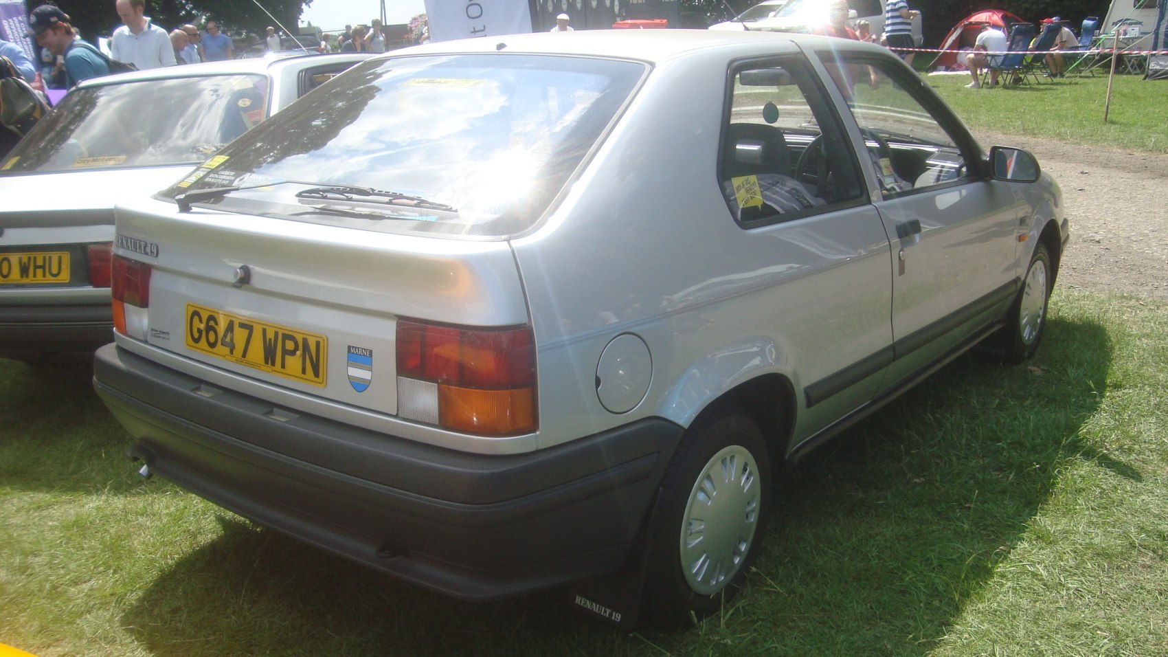 Rear-side view of a silver 1988 hatchback with distinct tail lights and rear bumper.